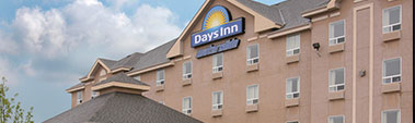 Small top-half view of Days Inn Red Deer, Alberta with the corporate logo and a waterslide sign placed at the peak of the hotel.