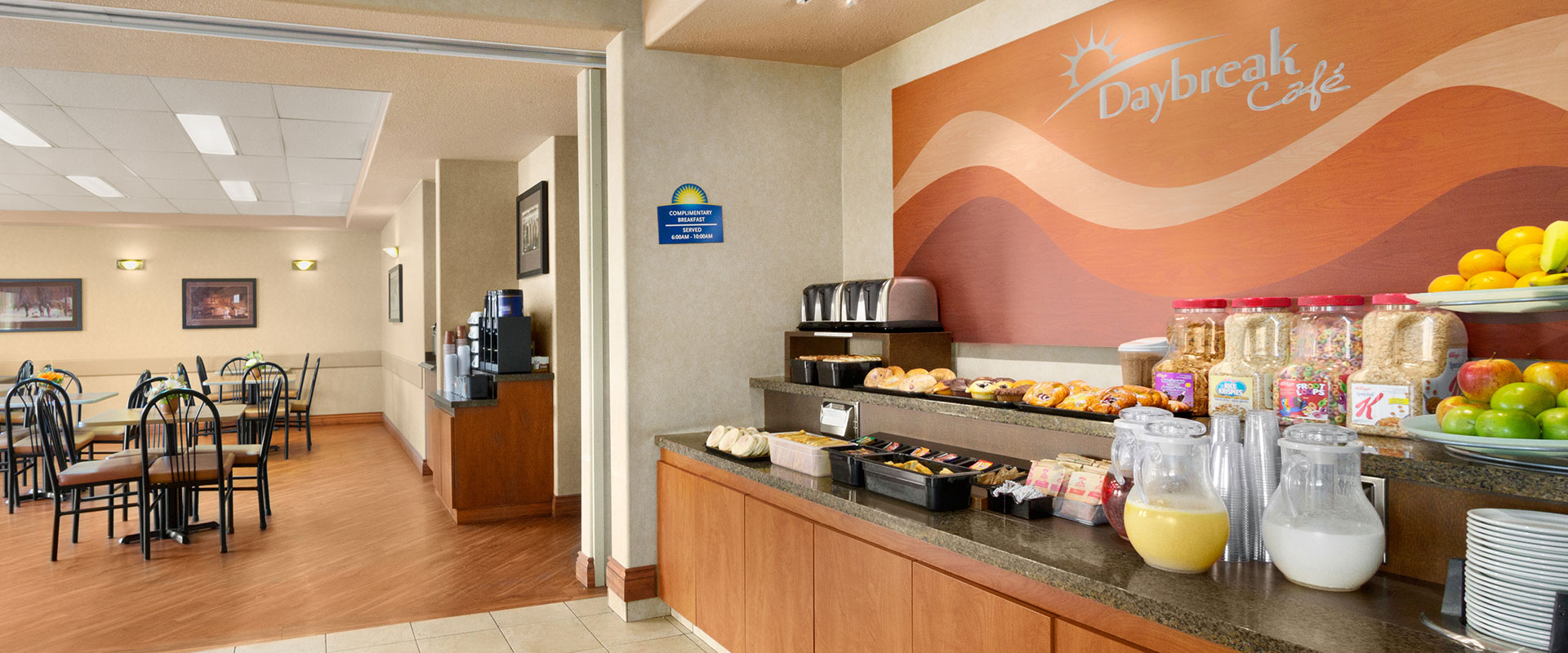 Large view of the breakfast bar at Days Inn Red Deer, Alberta stocked with muffins, danishes, cereals and beverages for guests.
