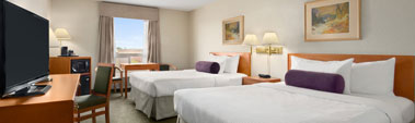 Small photo of the business class room at Days Inn Red Deer, Alberta with two beds, desks, chairs and lamps.